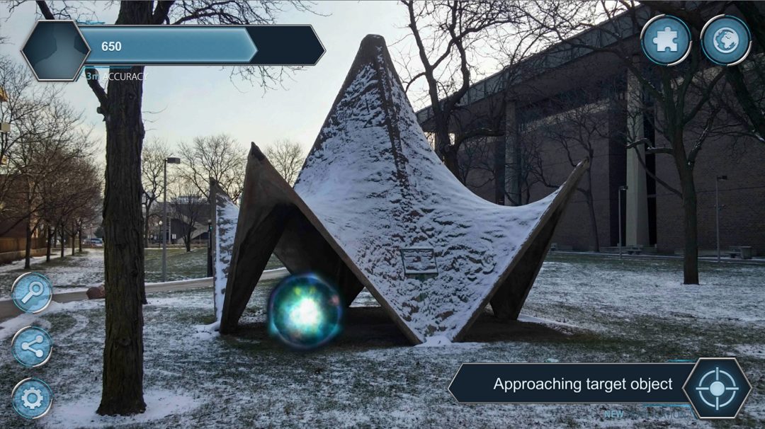 A sample camera view of the mobile application showing the user arriving in proximity of a virtual object. The on-screen buttons provide user interaction; the upper-left bar provides a score and the current GPS accuracy.