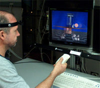 A user interacts with Dynallax, wearing a tracking sensor on a headband. Eventually, Dynallax tracking will be camera-based and tetherless.