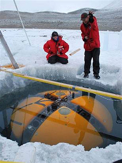 ENDURANCE PI Peter Doran (right) and Vickie Segal greet the arrival of the bot at the secondary melt hole near the base of Taylor Glacier.