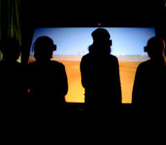 Four sixth graders explore the Field at the ImmersaDesk