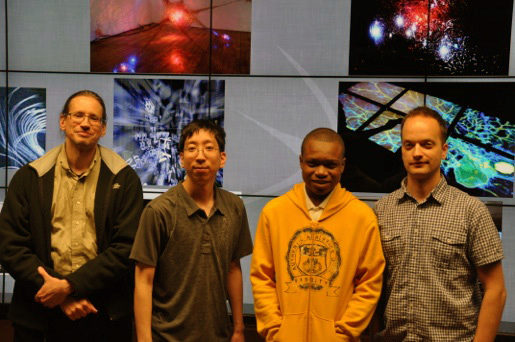 Spark apprentice Elonzo from Dodge Renaissance Academy stands with his UIC/EVL mentors